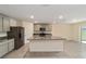 Bright kitchen featuring an island, granite countertops, stainless steel appliances, and tile flooring at 11136 Se 69Th Ter, Belleview, FL 34420