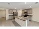 Open kitchen featuring gray cabinets, granite countertops, stainless appliances, and a large island at 11136 Se 69Th Ter, Belleview, FL 34420