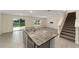 Open kitchen and living area with large island and granite countertops at 11136 Se 69Th Ter, Belleview, FL 34420