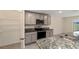 Modern kitchen with granite countertops and stainless steel appliances at 11136 Se 69Th Ter, Belleview, FL 34420