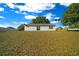 Expansive backyard featuring a sliding glass door leading to the home's interior at 1115 Silver Rd, Ocala, FL 34472
