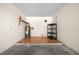 Spacious garage featuring hardwood flooring and ample storage space; includes a hot water tank and shelving at 1115 Silver Rd, Ocala, FL 34472