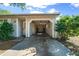 The attached garage features an open door, with a concrete driveway and lush greenery at 1115 Silver Rd, Ocala, FL 34472