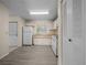 Functional kitchen featuring neutral cabinets, white appliances, and modern flooring at 1115 Silver Rd, Ocala, FL 34472