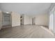 Open-concept living area featuring modern flooring, neutral walls, and ample natural light at 1115 Silver Rd, Ocala, FL 34472