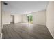 Bright and airy living room with modern flooring and a sliding glass door to the backyard at 1115 Silver Rd, Ocala, FL 34472