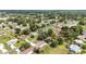 An aerial view shows a neighborhood with mature trees and well-maintained lawns at 11153 Sw 79Th Ave, Ocala, FL 34476