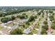 A neighborhood with mature trees and well-manicured lawns is captured in an aerial view at 11153 Sw 79Th Ave, Ocala, FL 34476
