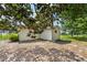 Backyard showing the back of the house, with a shaded area beneath mature trees at 11153 Sw 79Th Ave, Ocala, FL 34476