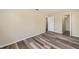 A neutral bedroom featuring plank flooring and an open closet for easy organization at 11153 Sw 79Th Ave, Ocala, FL 34476