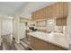 Bright kitchen with wood cabinets, modern flooring, and access to other rooms at 11153 Sw 79Th Ave, Ocala, FL 34476