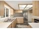 Well-lit kitchen featuring ample countertop space, wood cabinets, and modern flooring at 11153 Sw 79Th Ave, Ocala, FL 34476