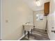Well-lit laundry room with a utility sink, storage cabinet, and modern flooring at 11153 Sw 79Th Ave, Ocala, FL 34476