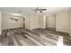 Open-concept living room with modern wood-look flooring and natural light at 11153 Sw 79Th Ave, Ocala, FL 34476