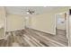 Spacious living room featuring wood-look floors, a ceiling fan, and ample light at 11153 Sw 79Th Ave, Ocala, FL 34476