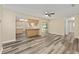 Open concept living area showcases stylish flooring, an adjacent kitchen, and natural light at 11153 Sw 79Th Ave, Ocala, FL 34476