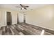 Spacious main bedroom with plank flooring, ceiling fan, and access to closet and bathroom at 11153 Sw 79Th Ave, Ocala, FL 34476