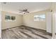 Main bedroom with neutral paint, two windows, plank flooring, and natural lighting at 11153 Sw 79Th Ave, Ocala, FL 34476