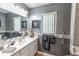 Updated bathroom featuring grey walls, laminate floors, and a single sink vanity at 1213 Meadowbend Dr, Leesburg, FL 34748
