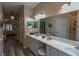 Spacious bathroom with dual sinks, framed mirrors, and plenty of cabinet space, beautifully lit at 1213 Meadowbend Dr, Leesburg, FL 34748