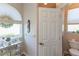 Well-lit bathroom with a window with an elegant shade and a step-in shower with grab bars at 1213 Meadowbend Dr, Leesburg, FL 34748