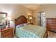 Comfortable bedroom with wood furniture and a large window for plenty of natural light at 1213 Meadowbend Dr, Leesburg, FL 34748