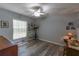 Home office/bedroom featuring laminate floors, light-filled windows, and neutral paint at 1213 Meadowbend Dr, Leesburg, FL 34748