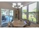 Bright dining nook featuring views to the backyard, complete with a decorative grandfather clock at 1213 Meadowbend Dr, Leesburg, FL 34748