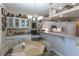 Bright dining area with a unique table and decorative accents, located next to the kitchen at 1213 Meadowbend Dr, Leesburg, FL 34748