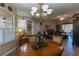 Dining room with wood table, chandelier, and views into the cozy living space at 1213 Meadowbend Dr, Leesburg, FL 34748