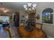 Dining room featuring a wood table set for dinner and a decorative chandelier for elegance at 1213 Meadowbend Dr, Leesburg, FL 34748
