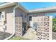 Side of the house with a door, AC unit, and some cinder block privacy walls at 1213 Meadowbend Dr, Leesburg, FL 34748