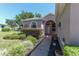 The arched entryway and landscaped yard welcome you to this charming three car garage home at 1213 Meadowbend Dr, Leesburg, FL 34748