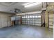 Spacious garage featuring a concrete floor, ample storage cabinets, and an automatic garage door opener at 1213 Meadowbend Dr, Leesburg, FL 34748