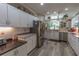 Kitchen with stainless steel appliances and white cabinets that offer ample storage space at 1213 Meadowbend Dr, Leesburg, FL 34748