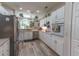 Bright kitchen featuring white cabinets, stainless steel appliances, and modern flooring at 1213 Meadowbend Dr, Leesburg, FL 34748