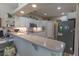 Modern kitchen featuring lots of white cabinets, stone countertops, and a stainless steel refrigerator at 1213 Meadowbend Dr, Leesburg, FL 34748