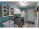 Bright laundry room with front load washer and dryer, ample cabinet space, and a utility sink at 1213 Meadowbend Dr, Leesburg, FL 34748