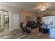 Comfortable living room with neutral paint and furnishings and sliding glass doors to the exterior at 1213 Meadowbend Dr, Leesburg, FL 34748
