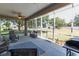 Relaxing screened-in patio featuring outdoor seating, ceiling fans, and a view of the backyard at 1213 Meadowbend Dr, Leesburg, FL 34748