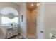 Modern bathroom featuring a step-in shower with grab bars, and unique decorative details at 1213 Meadowbend Dr, Leesburg, FL 34748