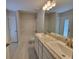 Well-lit bathroom featuring double sinks, a large mirror, and a shower-tub combination with a tiled floor at 13154 Sw 69Th Ct, Ocala, FL 34473