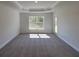 Spacious bedroom features a tray ceiling and plush carpeting and exterior access at 13154 Sw 69Th Ct, Ocala, FL 34473