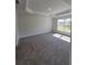 Spacious bedroom features a tray ceiling and plush carpeting at 13154 Sw 69Th Ct, Ocala, FL 34473