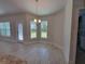 Bright dining area with stylish chandelier and views of the lush green backyard at 13154 Sw 69Th Ct, Ocala, FL 34473