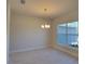 Bright dining room featuring tile floors, a chandelier, and a large window at 13154 Sw 69Th Ct, Ocala, FL 34473
