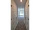 Hallway view of bedroom featuring plush carpeting and exterior views at 13154 Sw 69Th Ct, Ocala, FL 34473