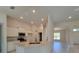 Bright kitchen with granite countertops, white cabinets, and stainless steel appliances at 13154 Sw 69Th Ct, Ocala, FL 34473