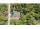 Aerial view of home with private driveway, some fencing, and surrounded by many trees at 13164 Sw 78Th Place, Dunnellon, FL 34432