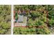 Aerial view of a home nestled among lush trees, showcasing the property and surrounding landscape at 13164 Sw 78Th Place, Dunnellon, FL 34432